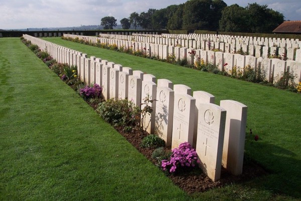 Rows of Commonwealth war graves and flower borders at Dieppe Canadian War Cemetery