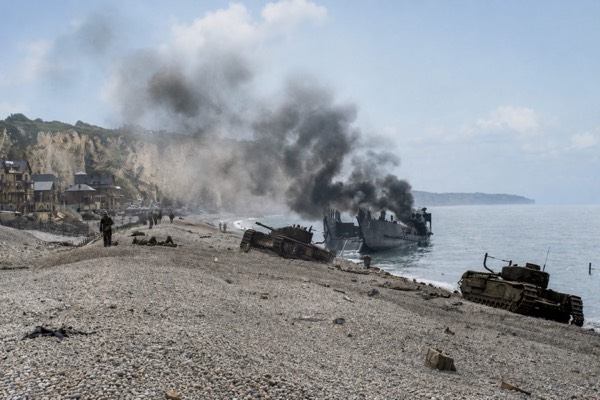 An artist's depiction of the Dieppe Raid, with disabled tanks and a landing craft on the shingle beach below the cliffs