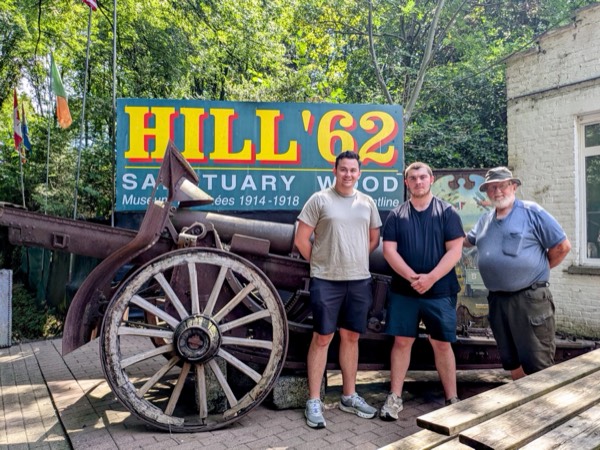 A guide and guests at the Hill 62 Sanctuary Wood museum, with a preserved artillery piece