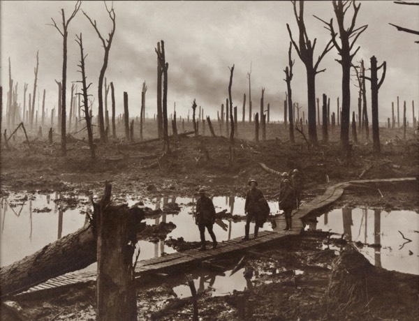 Archival photograph of soldiers crossing duckboards through the flooded Passchendaele battlefield