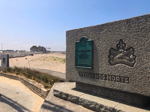A Canadian memorial reading 'À tous nos morts' overlooking Juno Beach