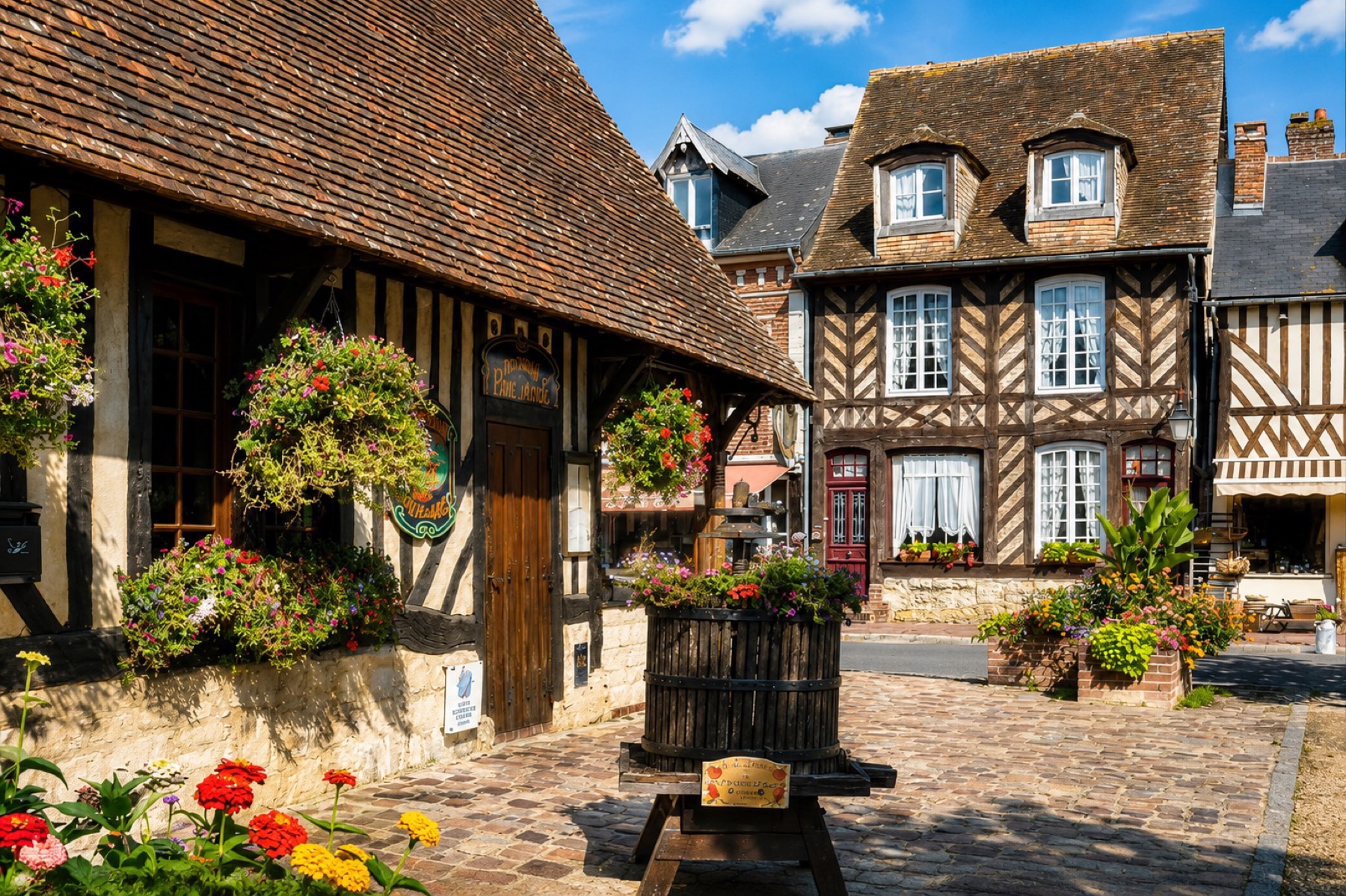 The timber-framed houses and flower-filled streets of Beuvron-en-Auge in the Pays d'Auge