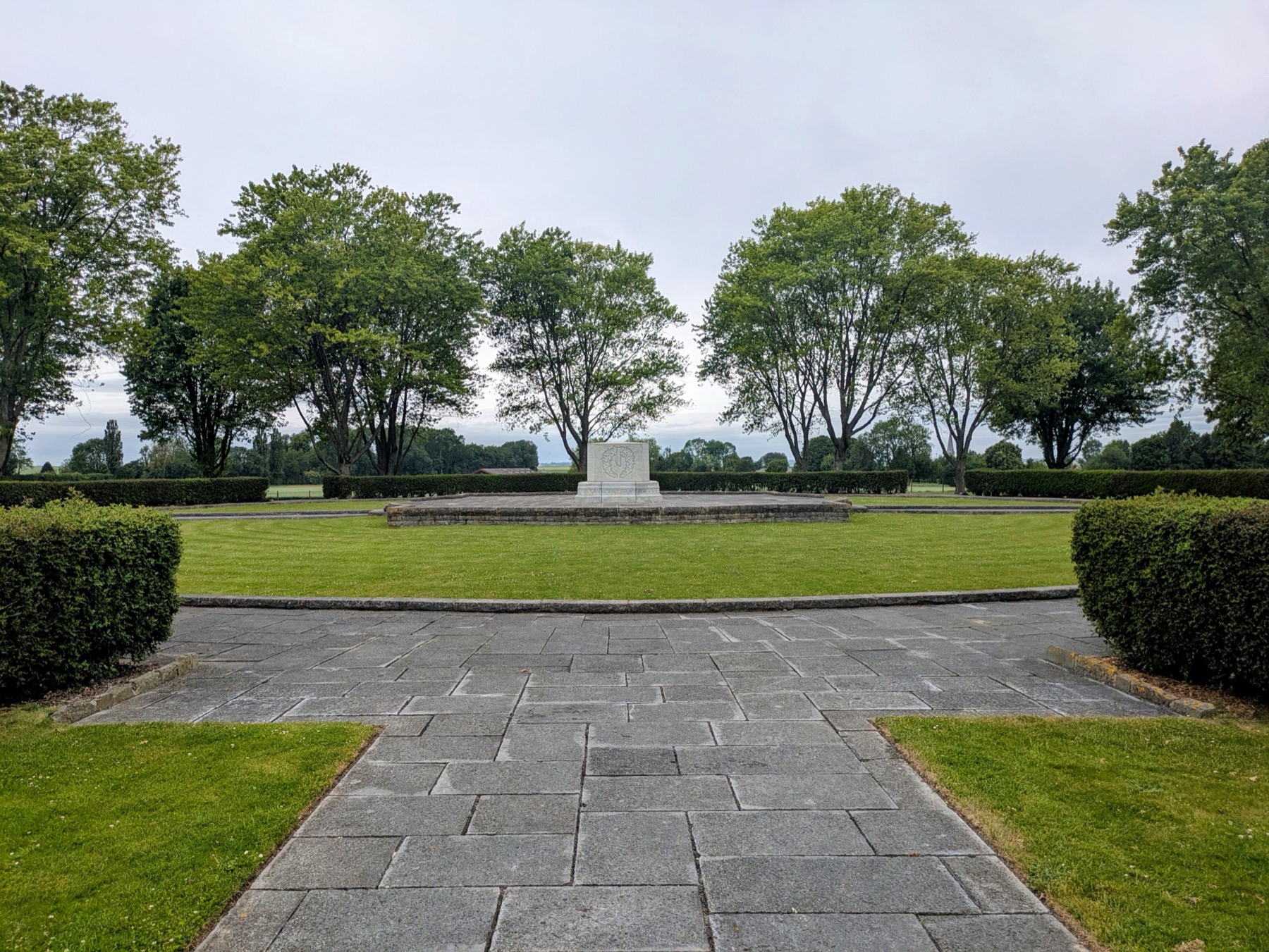 A Commonwealth War Cemetery on the Somme, framed by trees