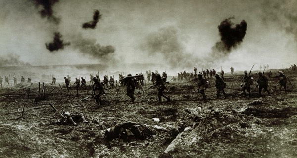 Archival photograph of Canadian soldiers advancing under bombardment
