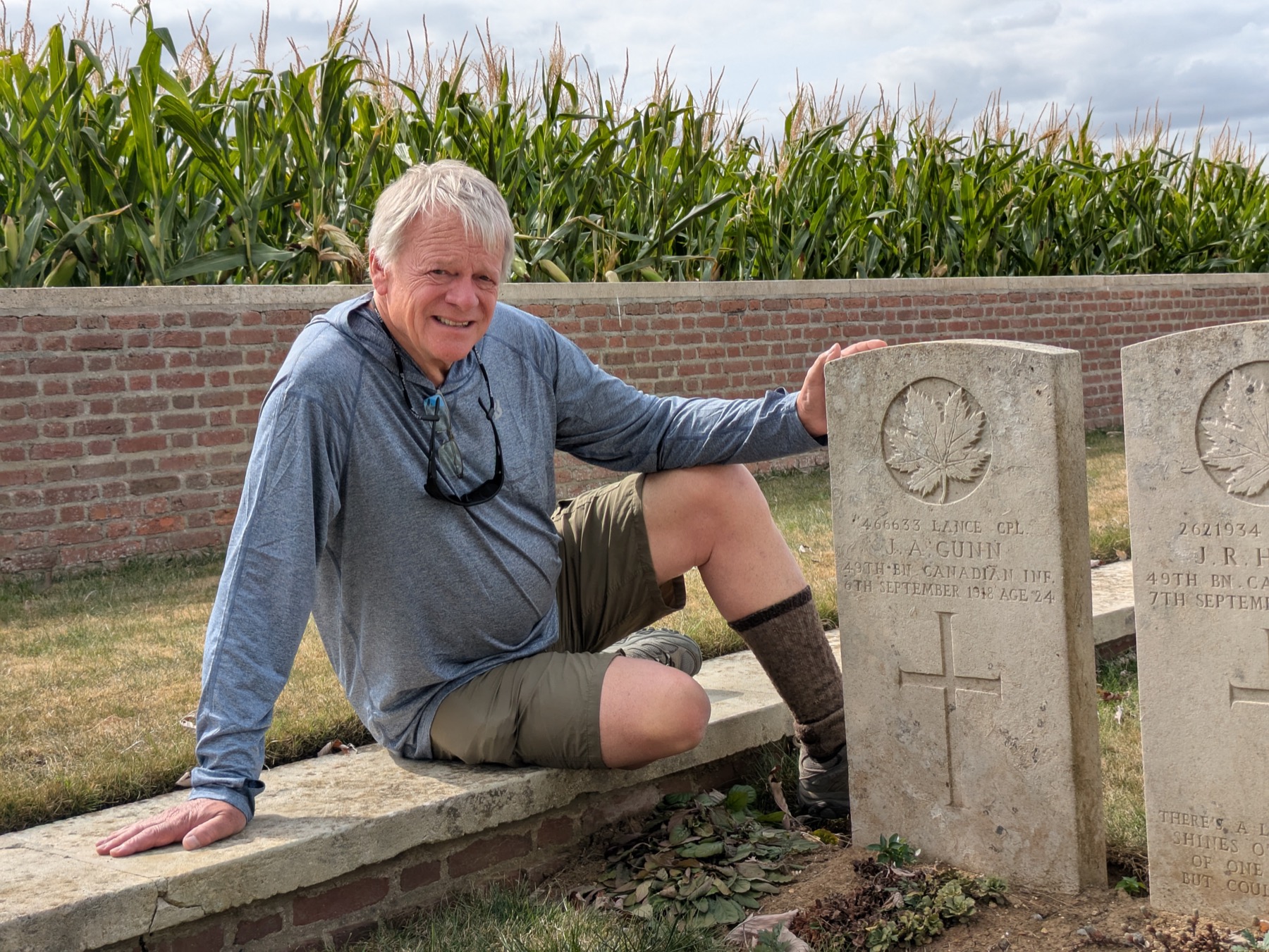 A guest visiting a Canadian war grave marked with a maple leaf